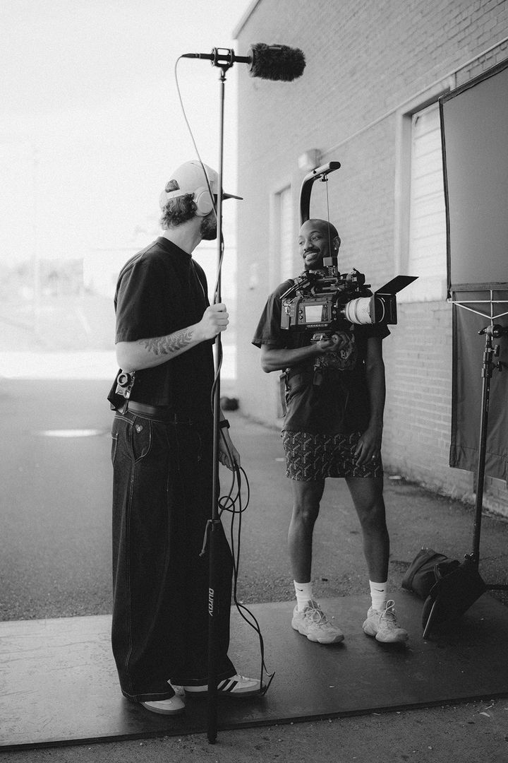 Boom operator and camera operator between takes on set