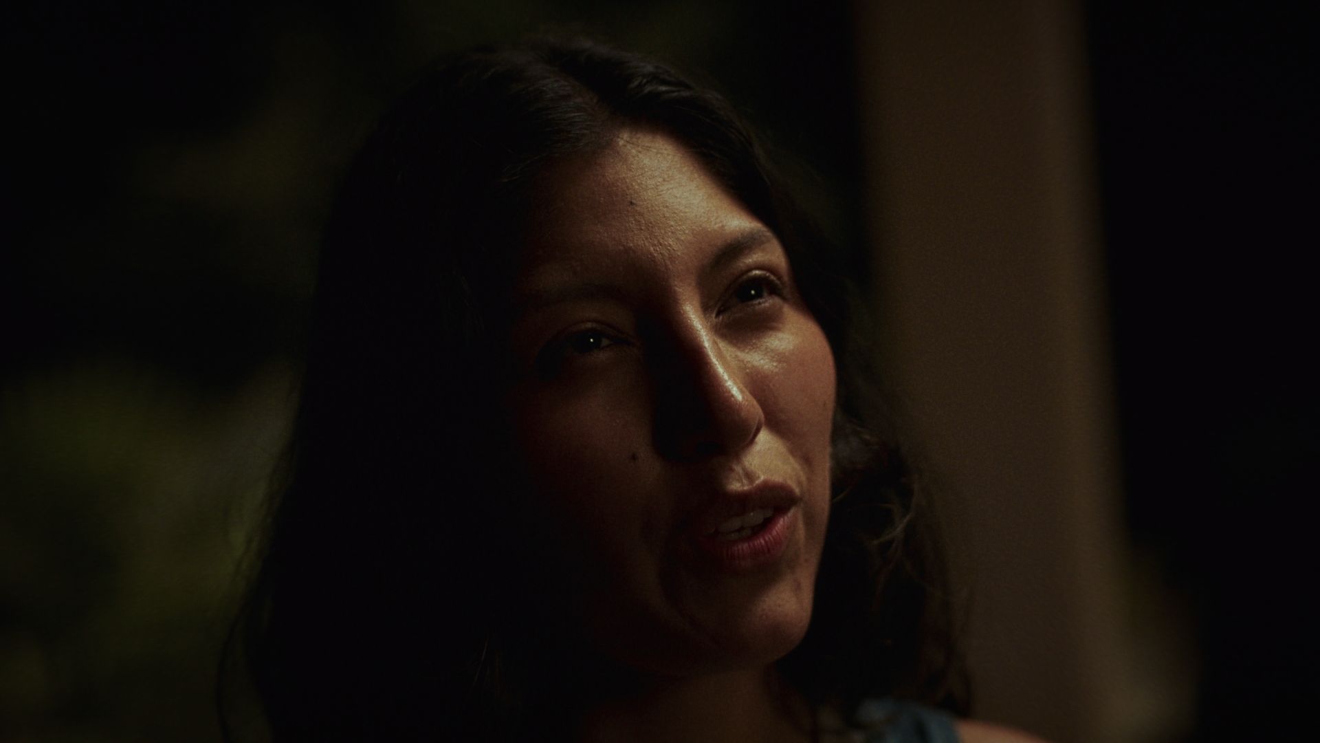 Still from Walk Away: a woman mid-argument, lit by a single light at night